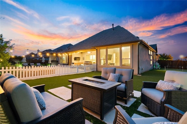 2500 Yuma Trl, Leander, TX 78641 - patio terrace at dusk featuring an outdoor living space with a fire pit, a fenced backyard, and a patio area