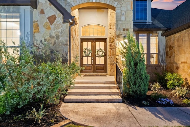 2500 Yuma Trl, Leander, TX 78641 - property entrance with stone siding, french doors, and a shingled roof