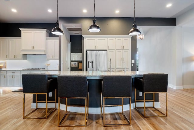 2500 Yuma Trl, Leander, TX 78641 - kitchen with stainless steel appliances, decorative backsplash, white cabinetry, light stone counters, and recessed lighting