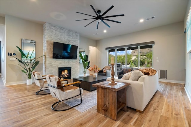 2500 Yuma Trl, Leander, TX 78641 - living room with ceiling fan, a stone fireplace, light wood-style flooring, and recessed lighting