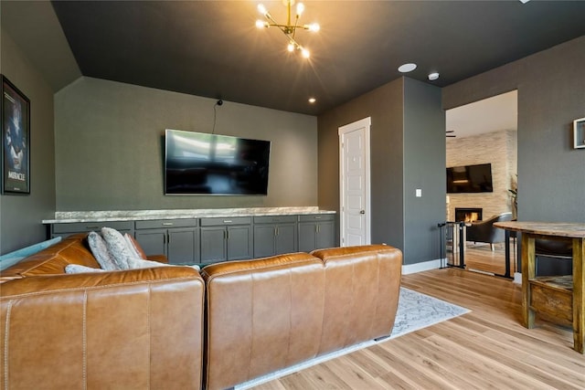 2500 Yuma Trl, Leander, TX 78641 - living area featuring light wood-style floors, a fireplace, and vaulted ceiling