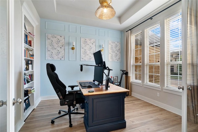 2500 Yuma Trl, Leander, TX 78641 - home office featuring a tray ceiling, light wood-style floors, and plenty of natural light