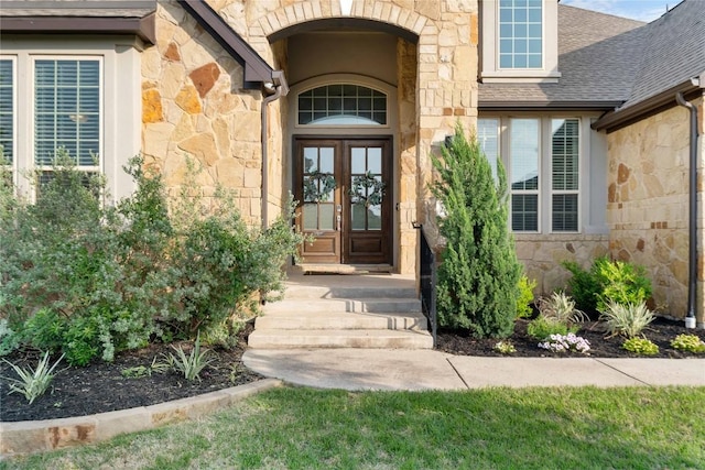 2500 Yuma Trl, Leander, TX 78641 - entrance to property with stone siding, french doors, and roof with shingles