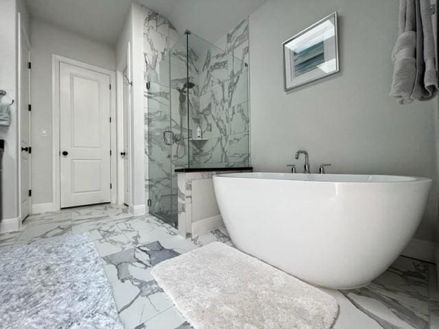 4201 Arques Ave, Round Rock, TX 78681 - bathroom with marble finish floors, a marble finish shower, a freestanding tub, and baseboards