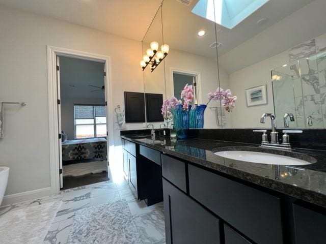 4201 Arques Ave, Round Rock, TX 78681 - full bath featuring a skylight, a stall shower, double vanity, marble finish flooring, and baseboards