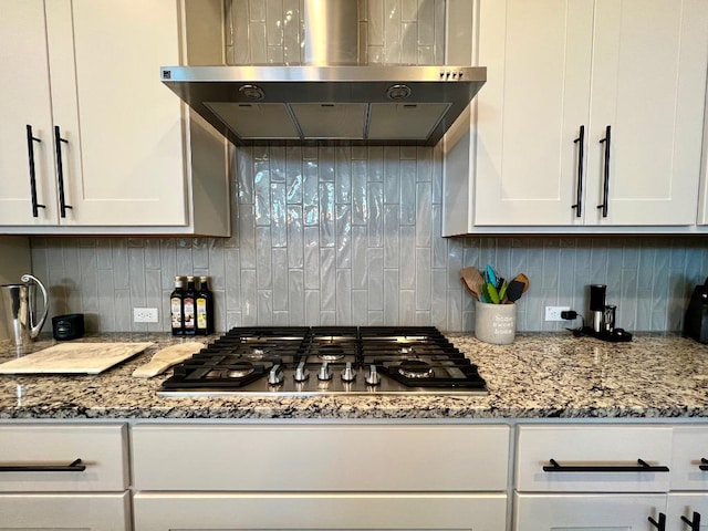 4201 Arques Ave, Round Rock, TX 78681 - kitchen with extractor fan, stainless steel gas stovetop, white cabinetry, and tasteful backsplash