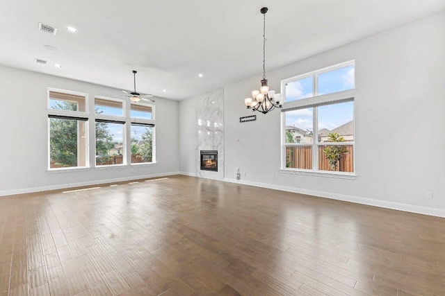 4201 Arques Ave, Round Rock, TX 78681 - unfurnished living room with plenty of natural light, baseboards, wood finished floors, and recessed lighting