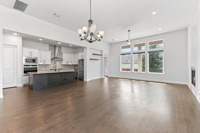 4201 Arques Ave, Round Rock, TX 78681 - kitchen with appliances with stainless steel finishes, wall chimney range hood, a chandelier, open floor plan, and ceiling fan