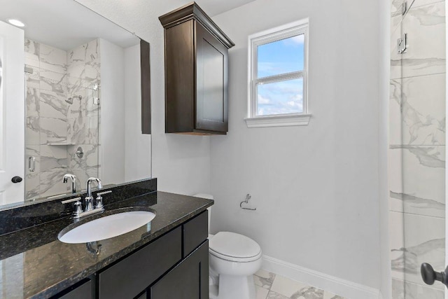 4201 Arques Ave, Round Rock, TX 78681 - full bathroom featuring marble look tile flooring, a stall shower, baseboards, toilet, and vanity