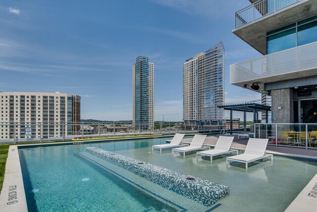 view of swimming pool with a view of city