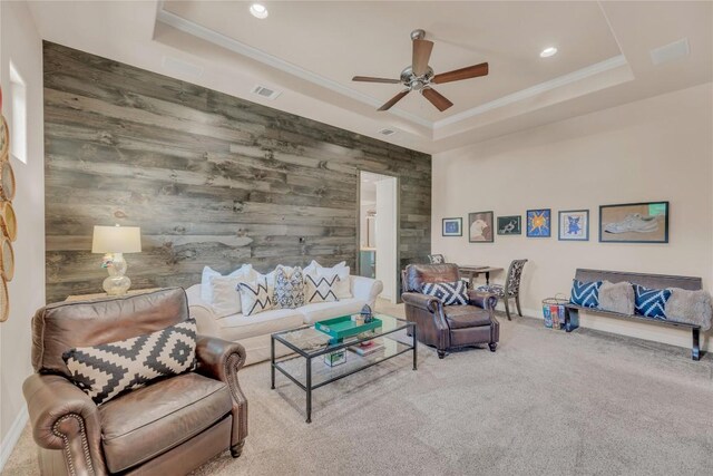 carpeted living room with a tray ceiling, visible vents, ceiling fan, and recessed lighting