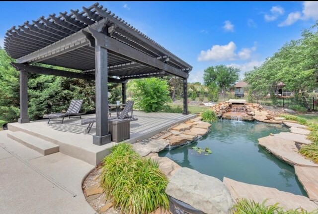 view of swimming pool featuring a fenced in pool, fence, a pergola, a small pond, and a patio
