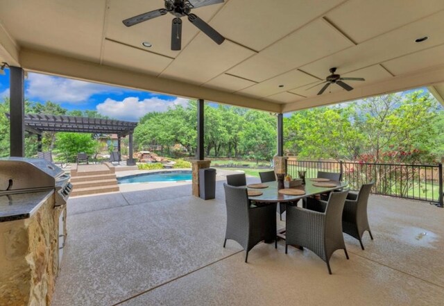 view of patio / terrace featuring a fenced in pool, a ceiling fan, a grill, exterior kitchen, and a pergola