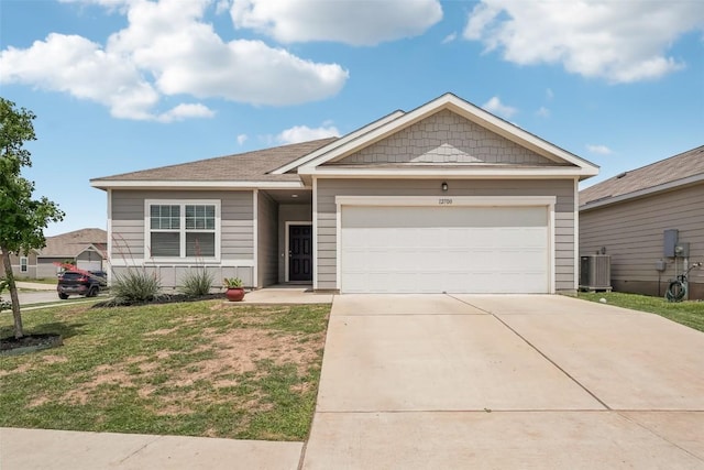 12700 Robert Taft St, Manor, TX 78653 - ranch-style house featuring driveway, a garage, and a front lawn
