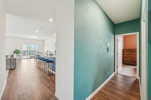 12700 Robert Taft St, Manor, TX 78653 - hall featuring wood finished floors, a textured wall, and recessed lighting