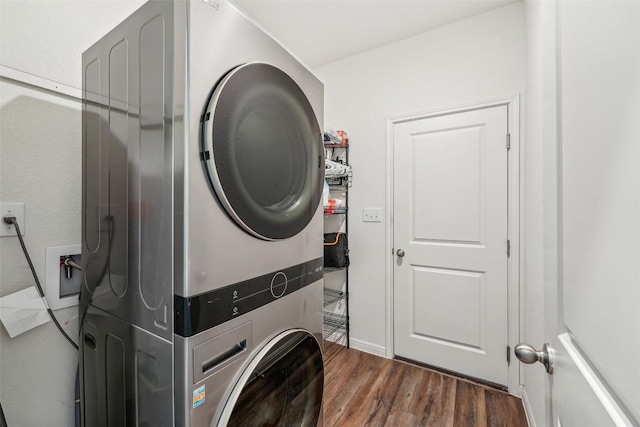 12700 Robert Taft St, Manor, TX 78653 - washroom featuring stacked washing machine and dryer and wood finished floors