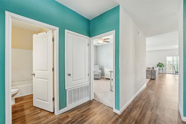 12700 Robert Taft St, Manor, TX 78653 - corridor featuring wood finished floors and baseboards