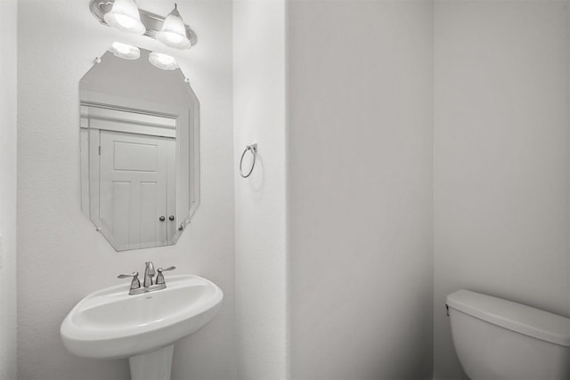 bathroom featuring toilet and a sink