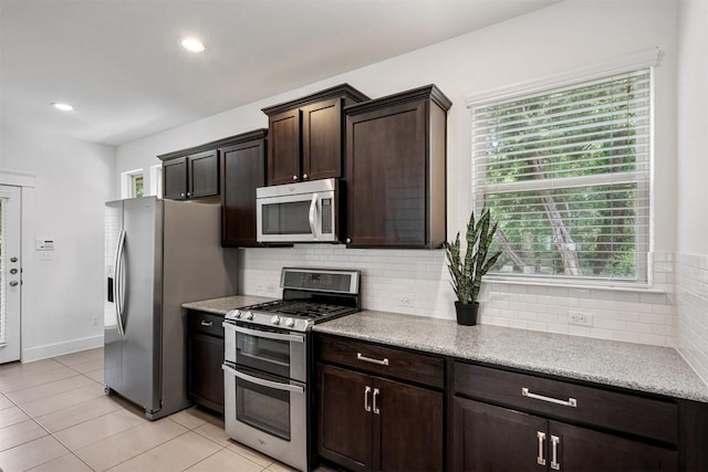 kitchen featuring dark brown cabinets, recessed lighting, backsplash, light tile patterned floors, and stainless steel appliances