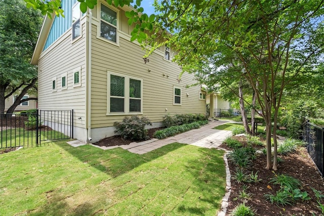 rear view of house featuring a fenced backyard, board and batten siding, and a lawn