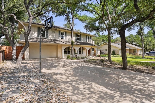 11204 Deadoak Ln, Austin, TX 78759 - traditional-style house with covered porch, concrete driveway, a garage, and brick siding