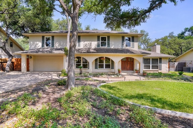 11204 Deadoak Ln, Austin, TX 78759 - view of front of house featuring a garage, brick siding, concrete driveway, and a chimney