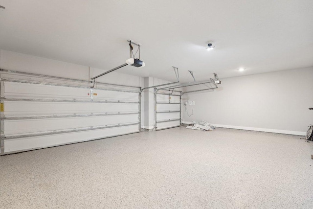 garage with baseboards and a garage door opener