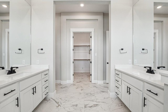 4216 Caroline Mae Cv, Pflugerville, TX 78660 - full bath featuring marble finish flooring, two vanities, a walk in closet, and recessed lighting