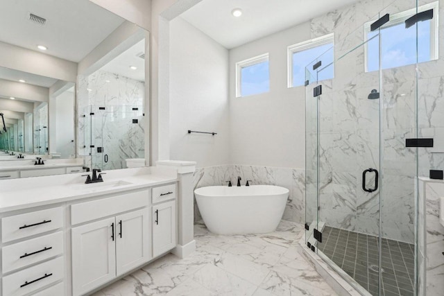 bathroom featuring marble finish floor, a marble finish shower, a freestanding bath, and visible vents