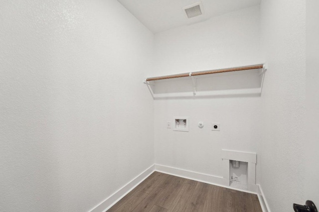 4216 Caroline Mae Cv, Pflugerville, TX 78660 - laundry room with hookup for an electric dryer, hookup for a washing machine, dark wood-type flooring, and gas dryer hookup