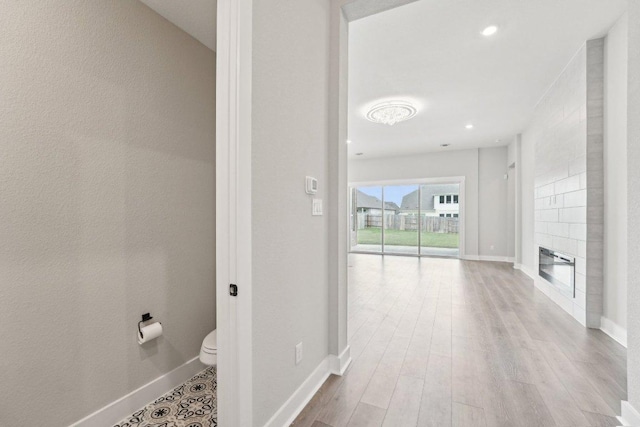 hall featuring recessed lighting, wood finished floors, and baseboards