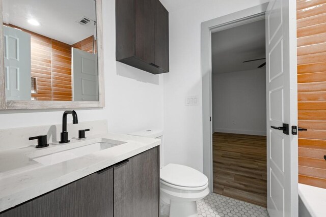 bathroom featuring toilet, baseboards, visible vents, tile patterned flooring, and vanity
