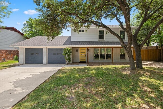 traditional-style house with concrete driveway, brick siding, and a garage