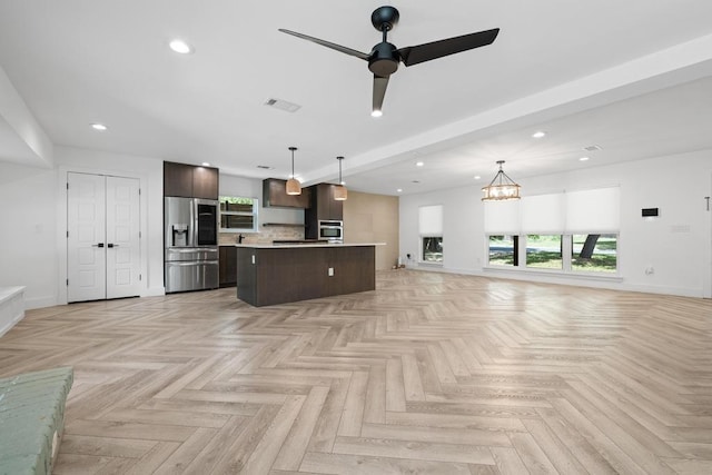 6905 Drexel Dr, Austin, TX 78723 - kitchen featuring stainless steel refrigerator with ice dispenser, open floor plan, wall oven, dark brown cabinetry, and recessed lighting