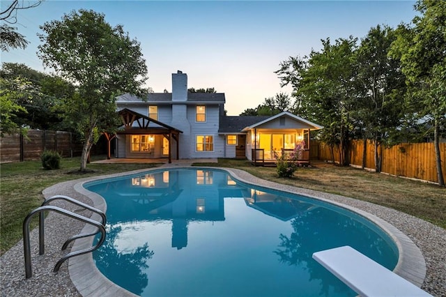 view of swimming pool with a fenced backyard, a yard, a wooden deck, and a fenced in pool