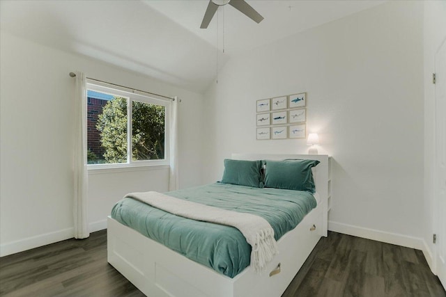 bedroom featuring baseboards, lofted ceiling, and wood finished floors