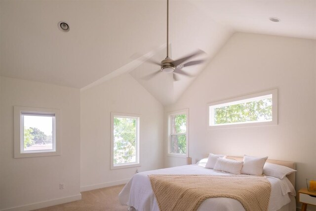 bedroom featuring light carpet, vaulted ceiling, baseboards, and a ceiling fan