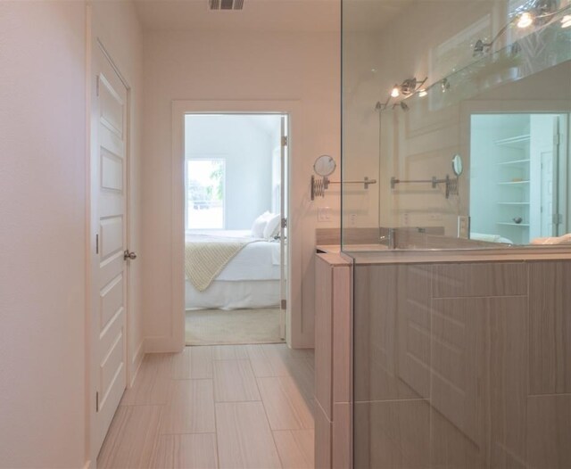 bathroom with visible vents, baseboards, ensuite bathroom, and vanity