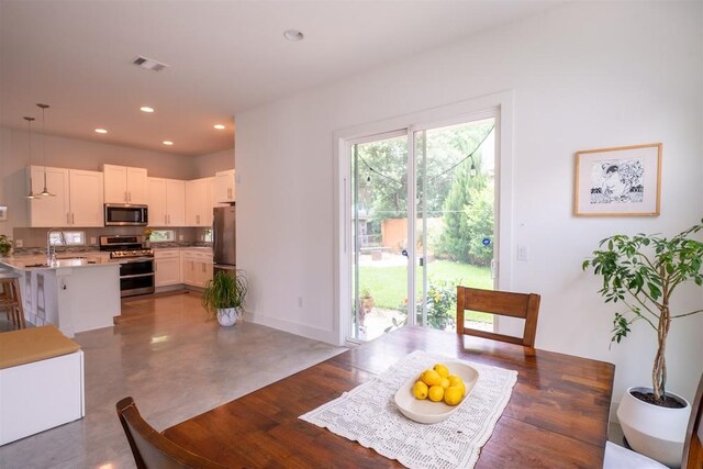 dining area with recessed lighting, visible vents, and baseboards