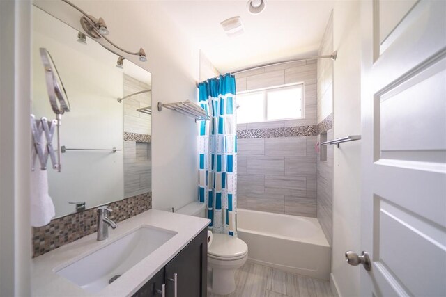 full bath featuring decorative backsplash, shower / bath combination with curtain, vanity, and toilet