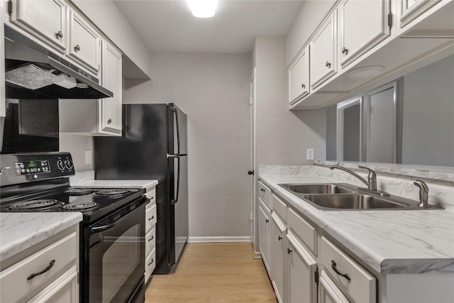 kitchen featuring black electric range oven, a sink, light wood finished floors, baseboards, and under cabinet range hood