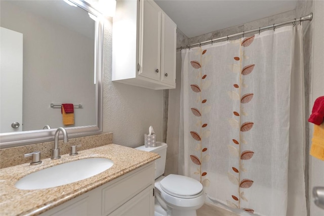 bathroom with toilet, vanity, and a shower with curtain