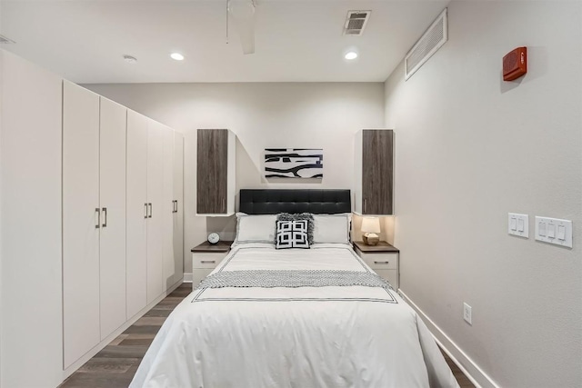 bedroom with recessed lighting, dark wood finished floors, visible vents, and baseboards