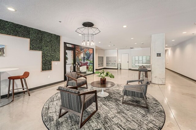 living area with baseboards, recessed lighting, and a textured ceiling