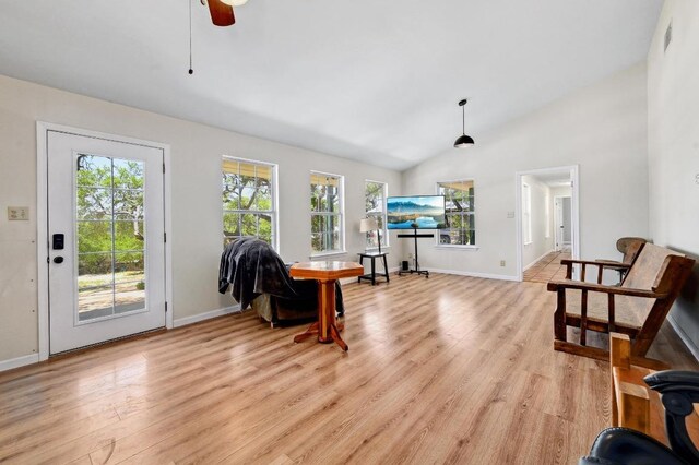 interior space featuring light wood-style floors, baseboards, and ceiling fan