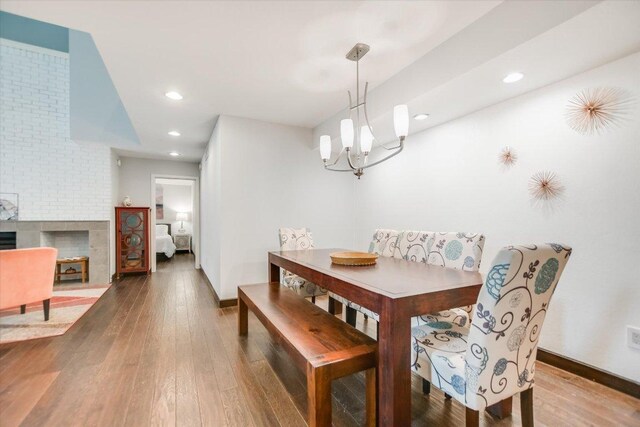 dining room featuring hardwood / wood-style flooring, baseboards, recessed lighting, and a chandelier