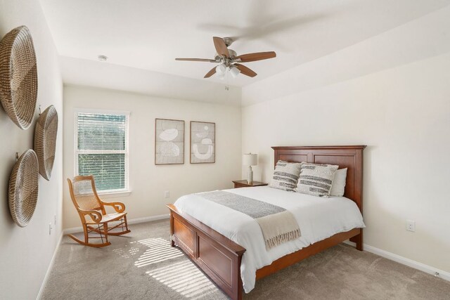 bedroom with light colored carpet, baseboards, and a ceiling fan