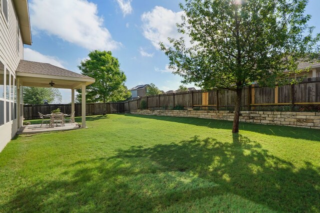 view of yard with a patio area, a fenced backyard, and ceiling fan