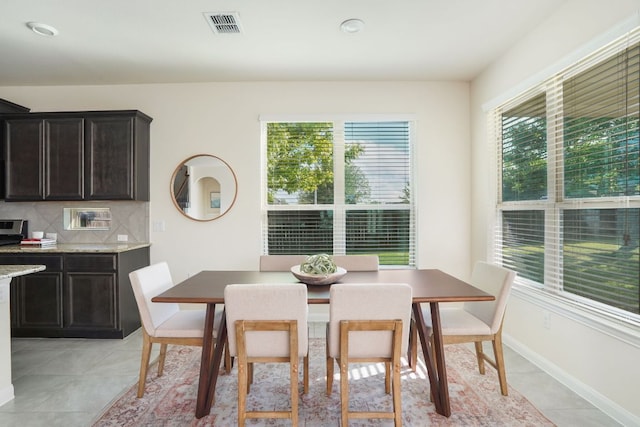 dining space with visible vents and light tile patterned floors