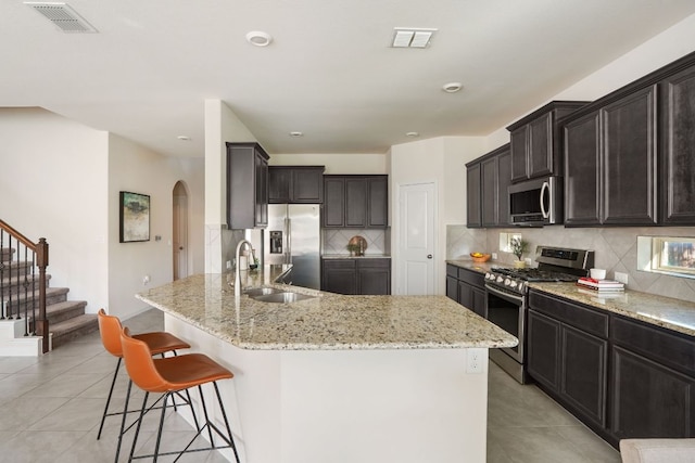 kitchen featuring visible vents, light tile patterned floors, stainless steel appliances, and a sink
